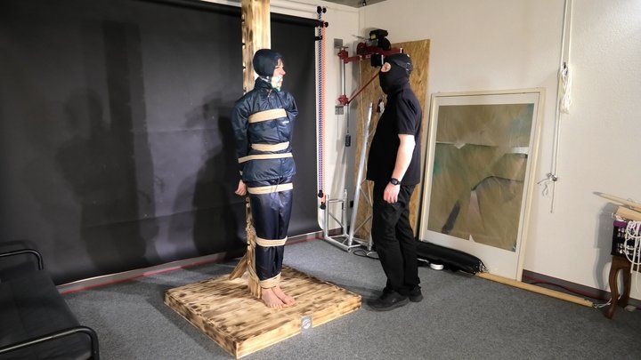 Lana tied and gagged and gagged to Post in shiny nylon Rainwear