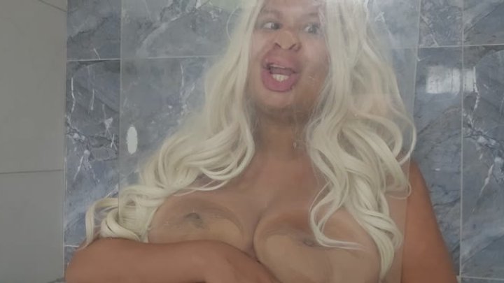 Blondie gets face and boobs stuck in the glass