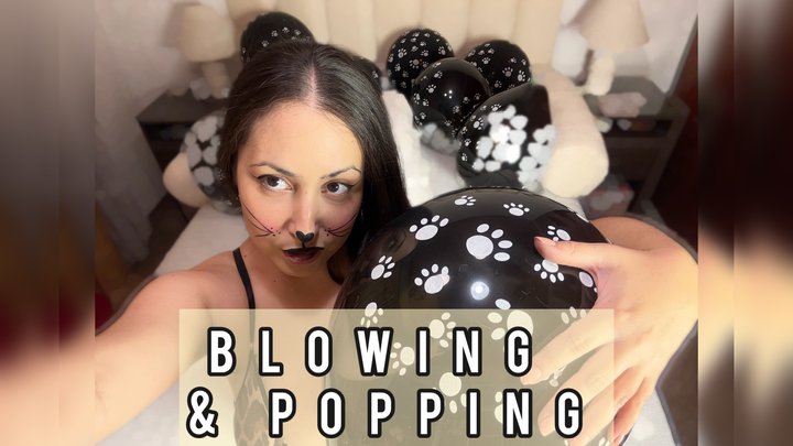 Sexy looner-girl dressed in leopard print blows up balloons and pops them with h