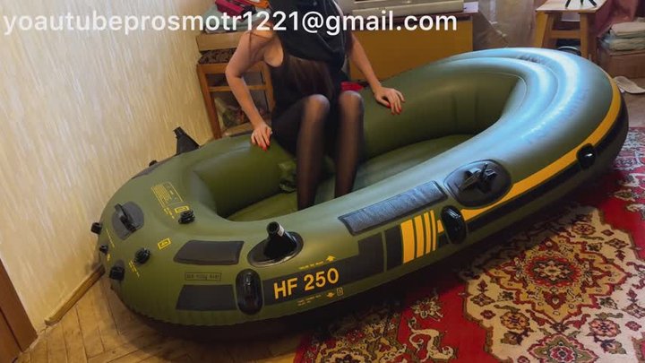 Nastya in black tights walks on an inflatable boat, steps on it, tramples it, pu