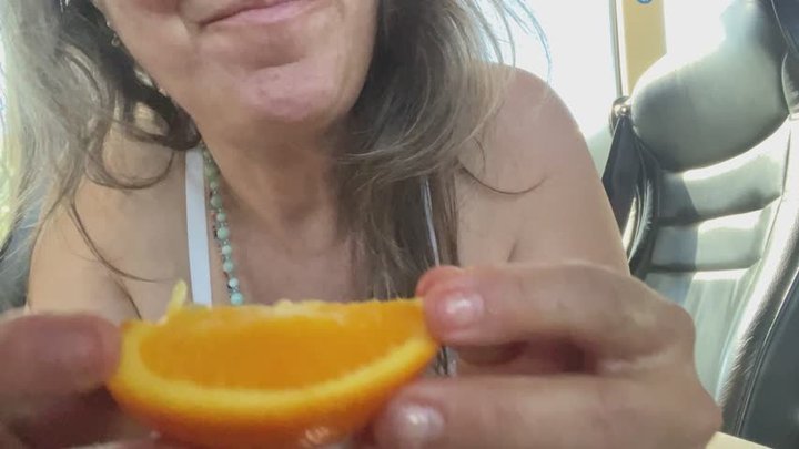 sucking oranges by the slice in her bra
