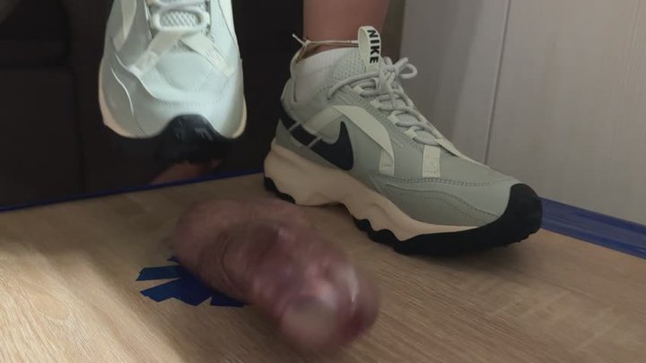 Grey Nike trampling sneakers job