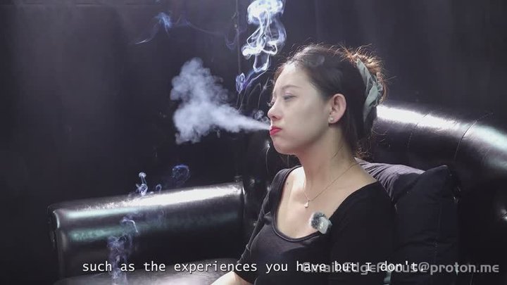 Asian Woman Lighting and Smoking Cigarette on Leather Sofa — XI1 4K