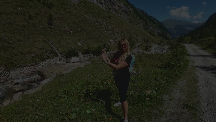 Evil-Lyn blows to pop btp a green 16inch Balloon in the Alps