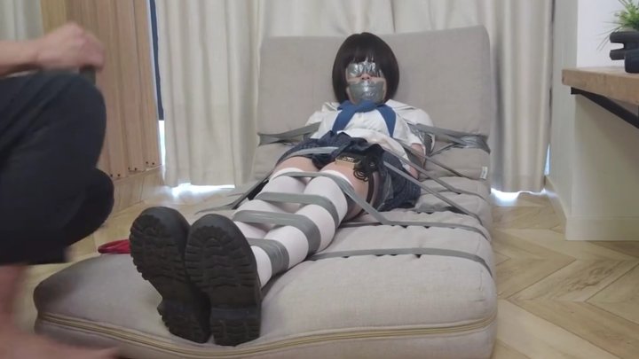 Girl in white stockings bound with tape on an air mattress