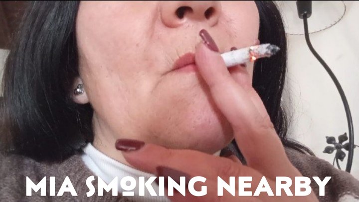 Mia smoking nearby