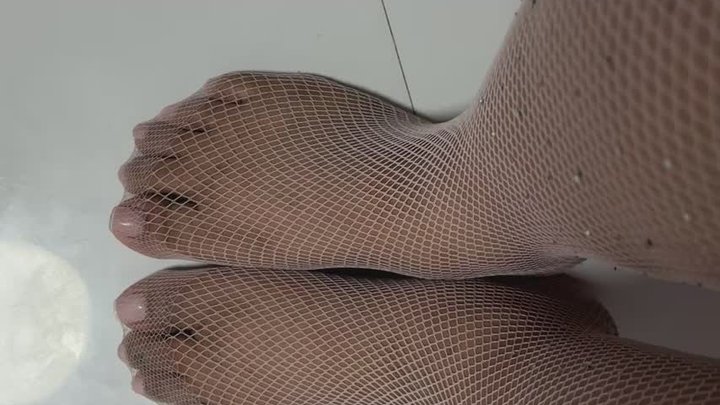 slowly wiggling my toes on my pink fishnets top view