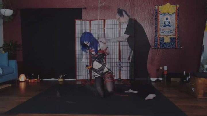 Kesh binds Lizzy Blue in a traditional shibari partial suspension where she is m