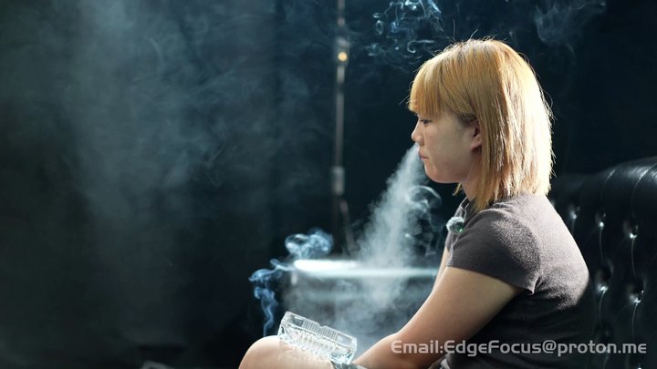 Sensual Smoking Girl: Deep Inhales and Thick Smoke Clouds on the Leather Sofa — 