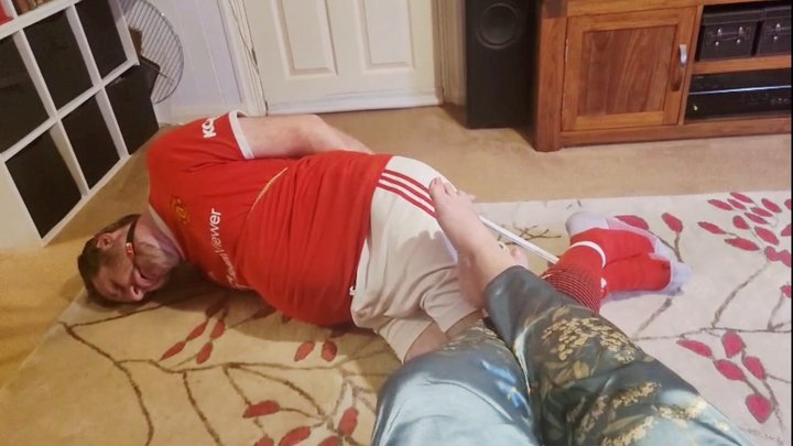Footballer bound and struggling at Miss M's barefeet