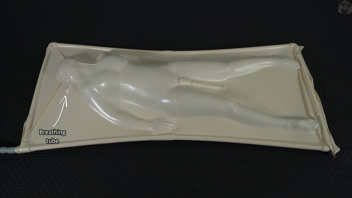 A girl has an orgasm from a vibrator while lying inside a white vacuum bed with 