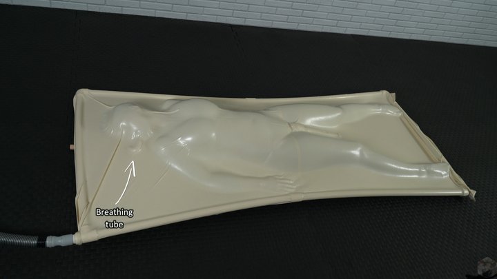 A girl has an orgasm from a vibrator while lying inside a white vacuum bed with 