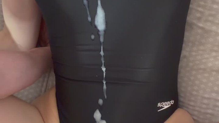 Covering black Speedo swimsuit with cum