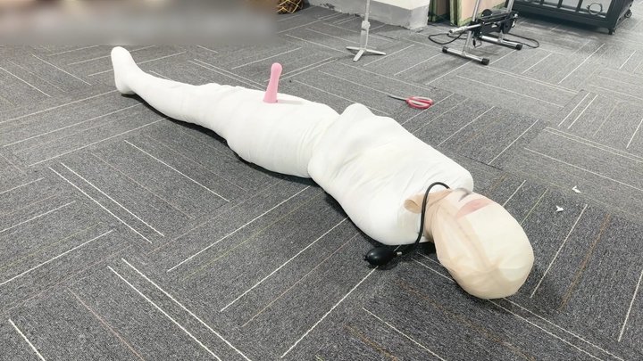 Girlfriend wrapped head-to-toe in gauze, inflatable gag in her mouth, vibrating 
